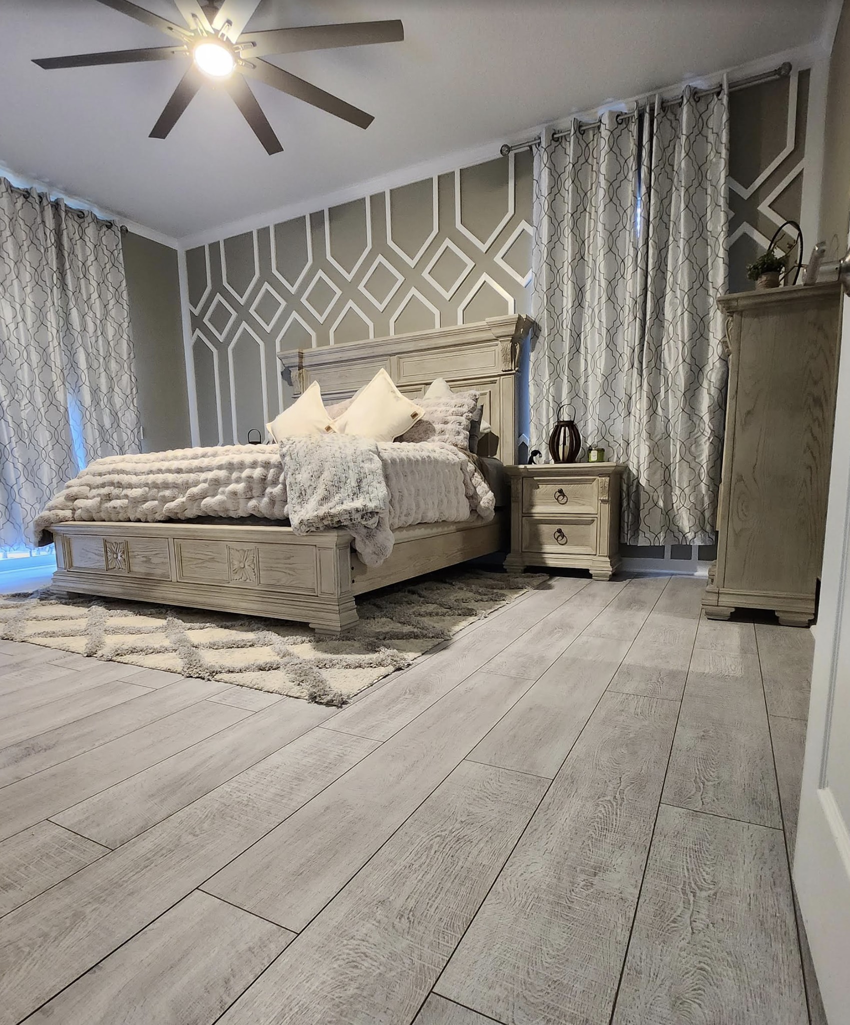 Stunning finished bedroom with new flooring, accent wall, and decor