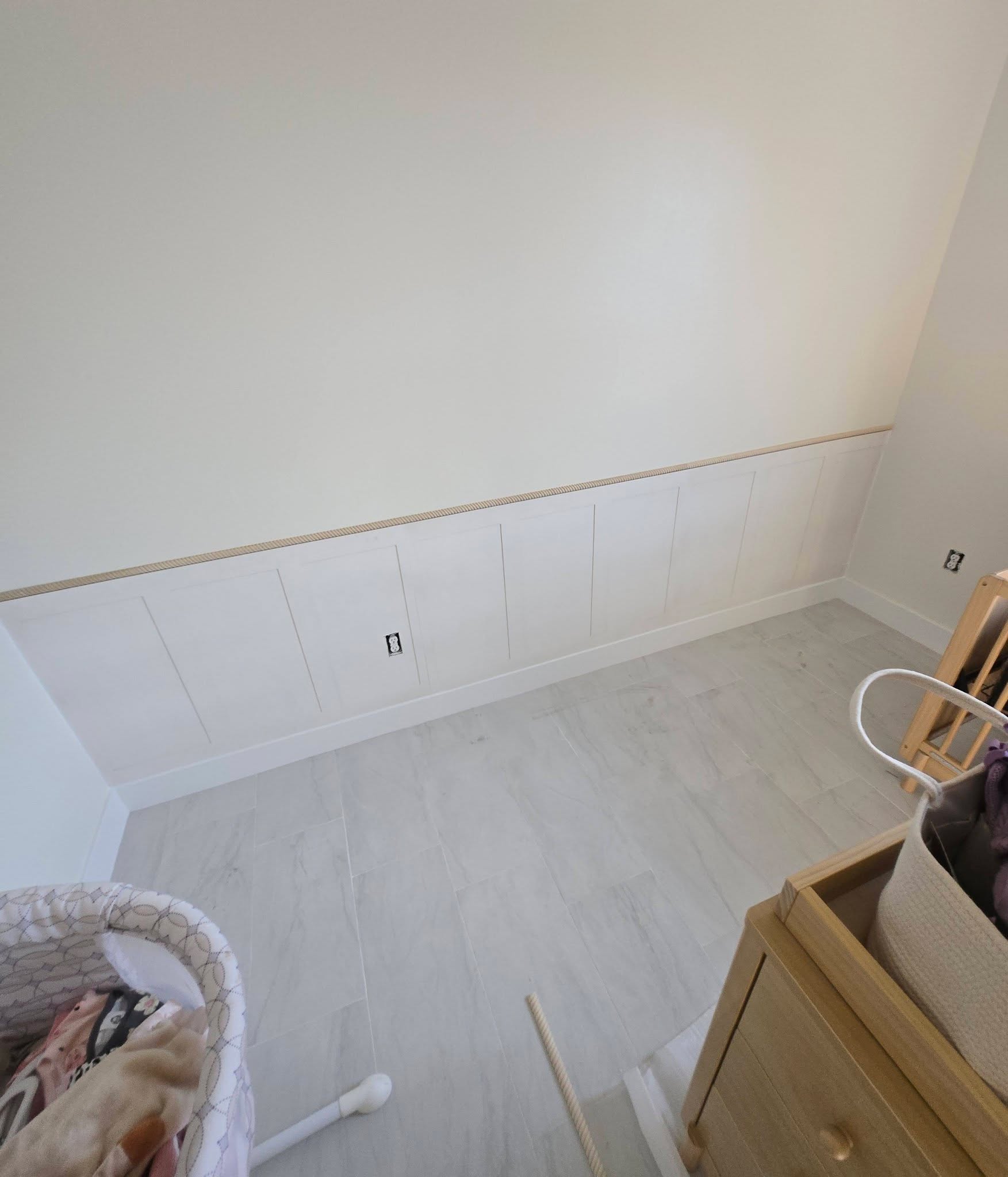 Nursery with custom wainscoting panels installed